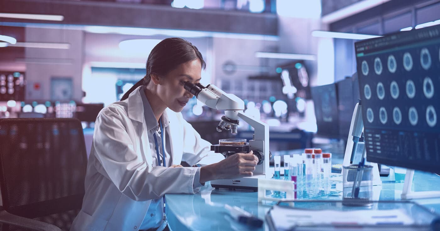 Researcher using a microscope in an analysis laboratory
