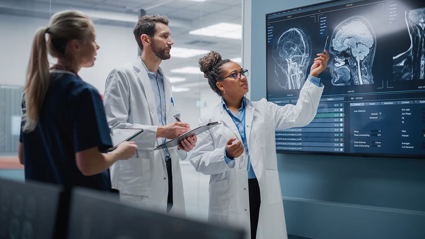 Scientific team analyzing imaging scans on a lab screen